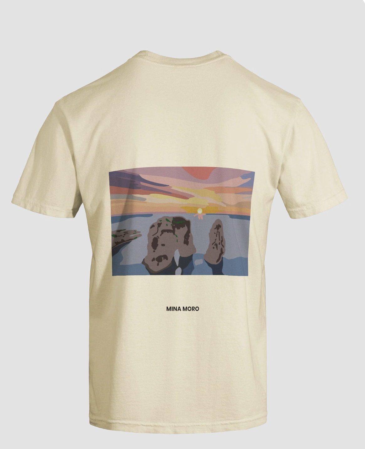 Cream t-shirt with a stylised Raouché rocks sunset print on the back